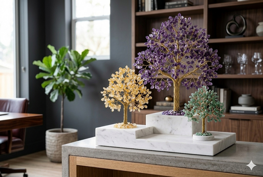 A curated collection of Amethyst, Citrine, and Aventurine crystal trees on a marble display, showcasing different gift options for Mother's Day.