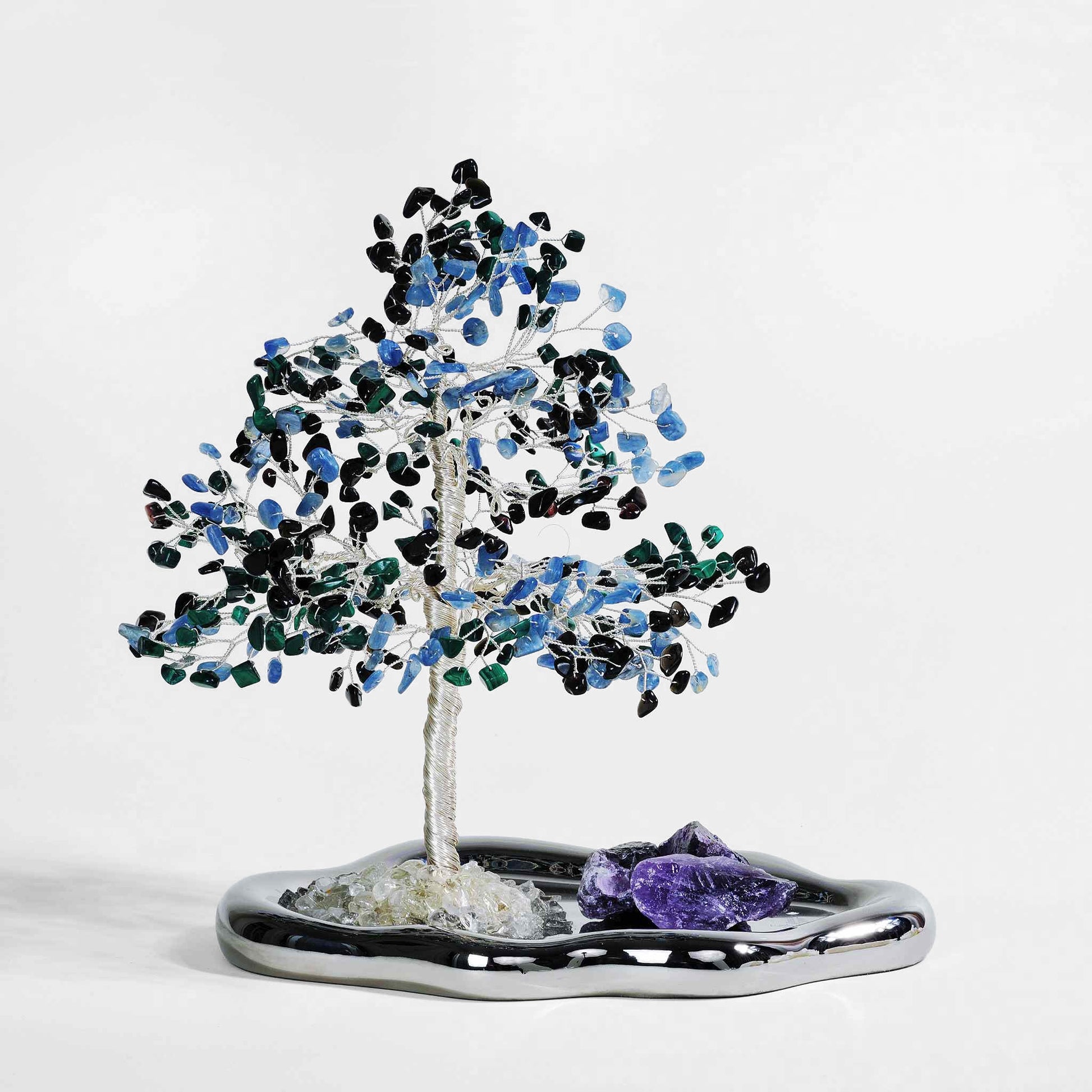a crystal tree made by obsidian, malachite, kyanite and amethyst